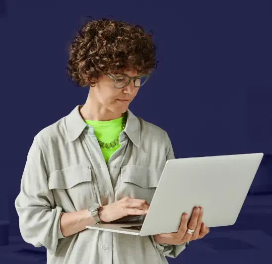 Woman with curly hair working on laptop